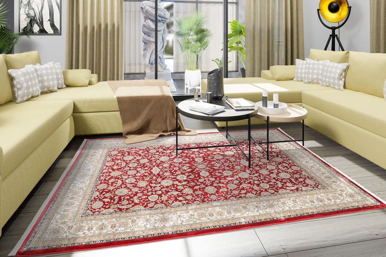 Ein traditioneller, klassischer, roter, Teppich mit Fransen liegt im Wohnzimmer auf dem Boden. - Ein traditioneller, klassischer, roter, Teppich mit Fransen liegt im Wohnzimmer auf dem Boden.